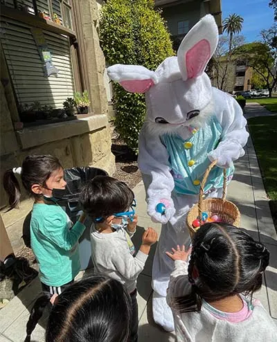 kids getting eggs from Peter Rabbit costume