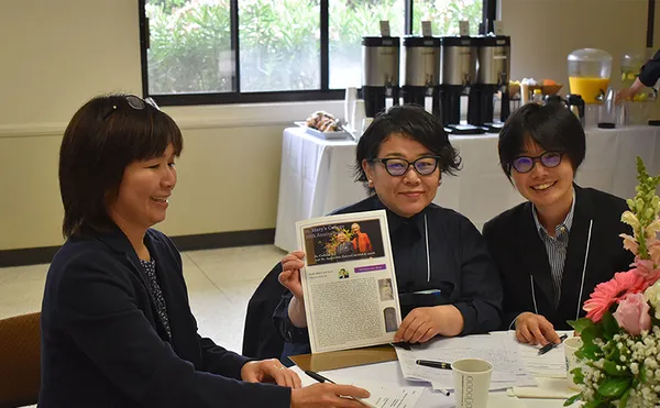 Women sitting at a table at a conference
