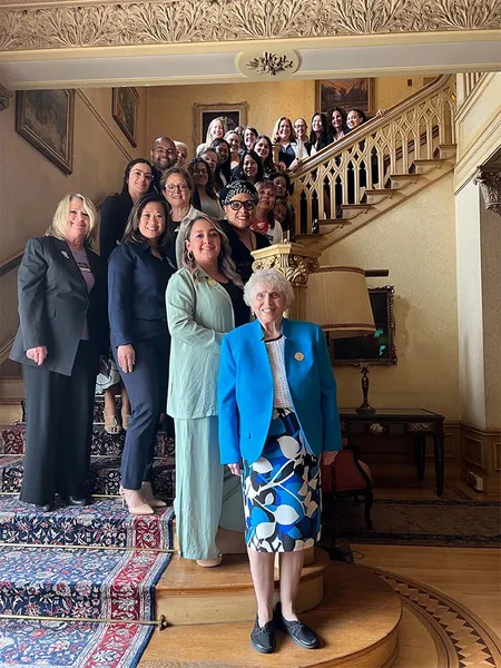 group from the Roy Adaptation Association conference posing on the Doheny Mansion stairs