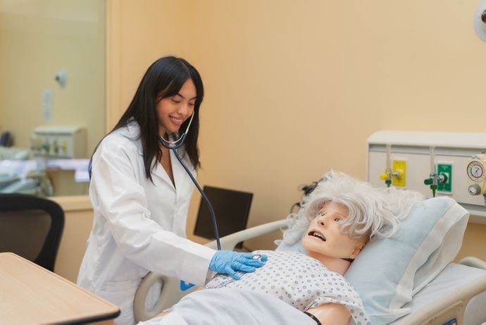 A student practicing techniques on a medical mannequin