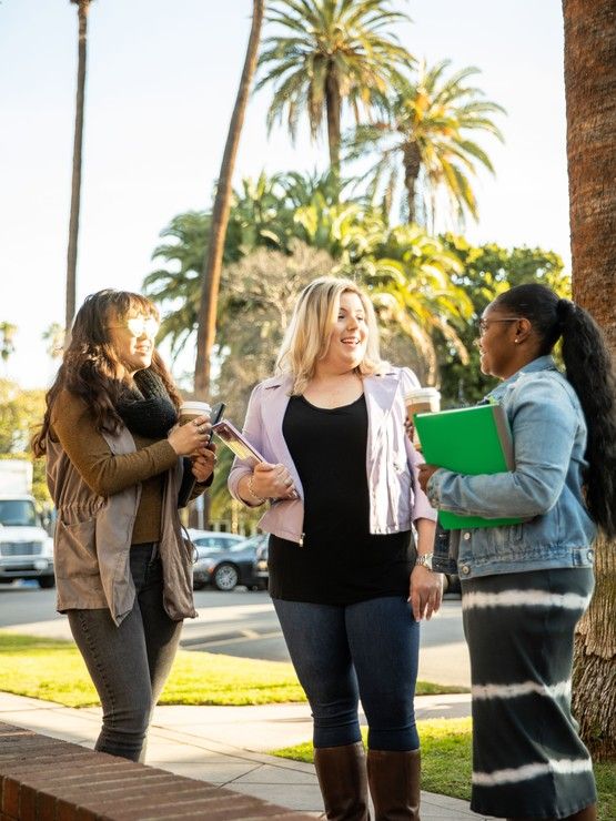 student and adult smiling together