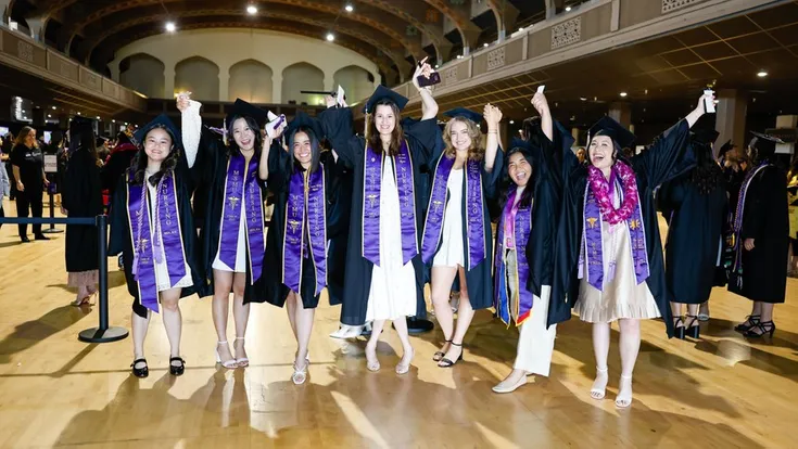 Students celebrate during the undergraduate commencement ceremony in the Shrine.