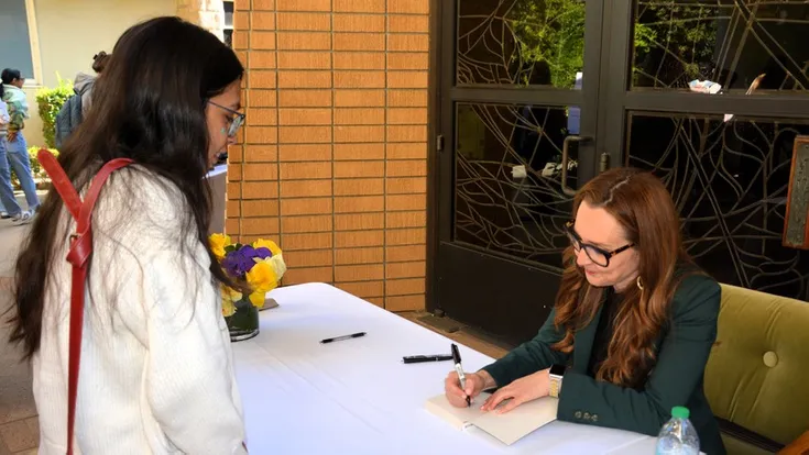 Lindsey Pollak signs copies of her books during her visit to the University.