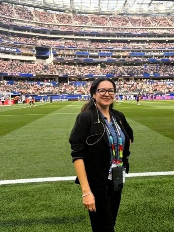 Crystal Calvillo on the field at SoFi Stadium, where she led venue technology operations for all eight FIFA World Cup 2026 matches played in Los Angeles, coordinating the systems that kept one of the tournament's busiest venues running.