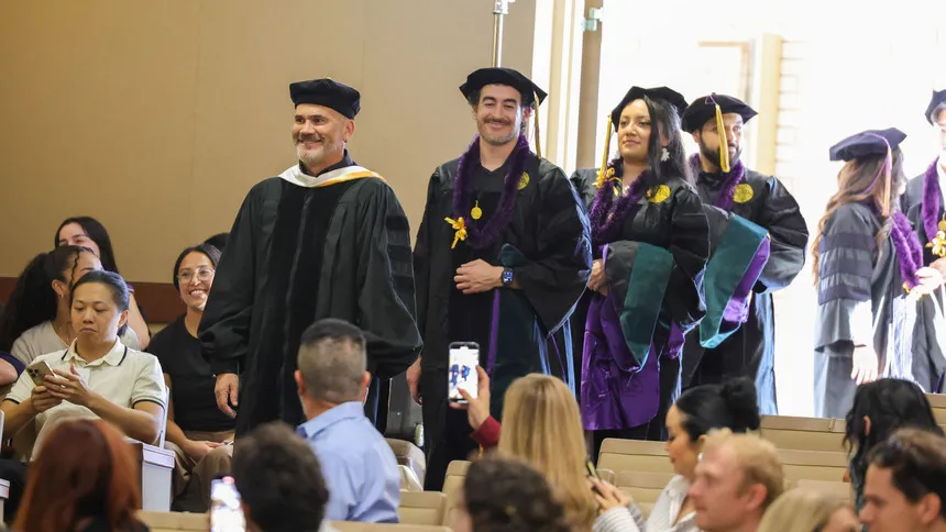 DPT Graduates walking into an auditorium