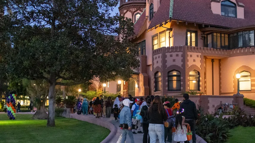 Parents and children gathered in front of the Doheny mansion